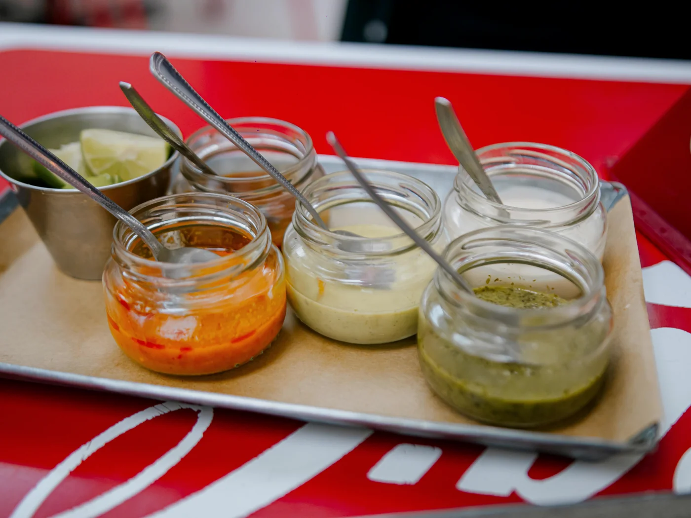 A range of sauces in glass jars showing different textures